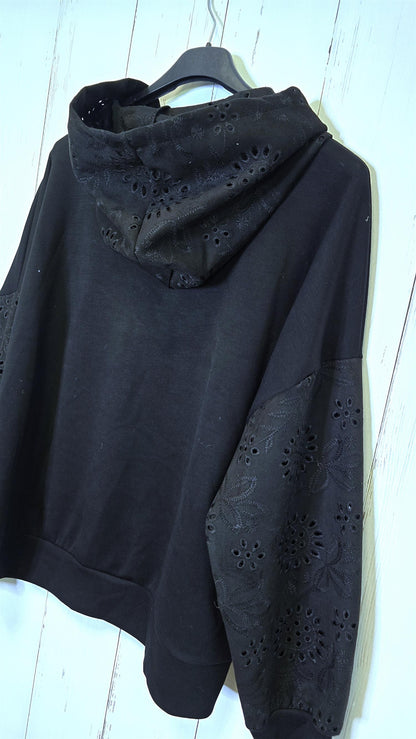 Sort genser med broderte detaljer