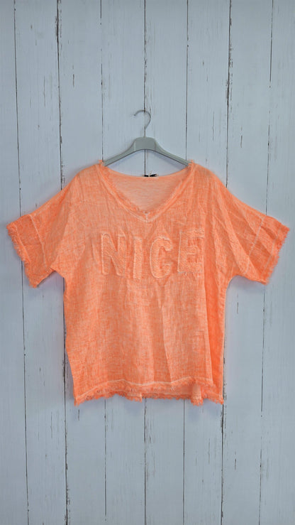 Orange oversized topp med “NICE”
